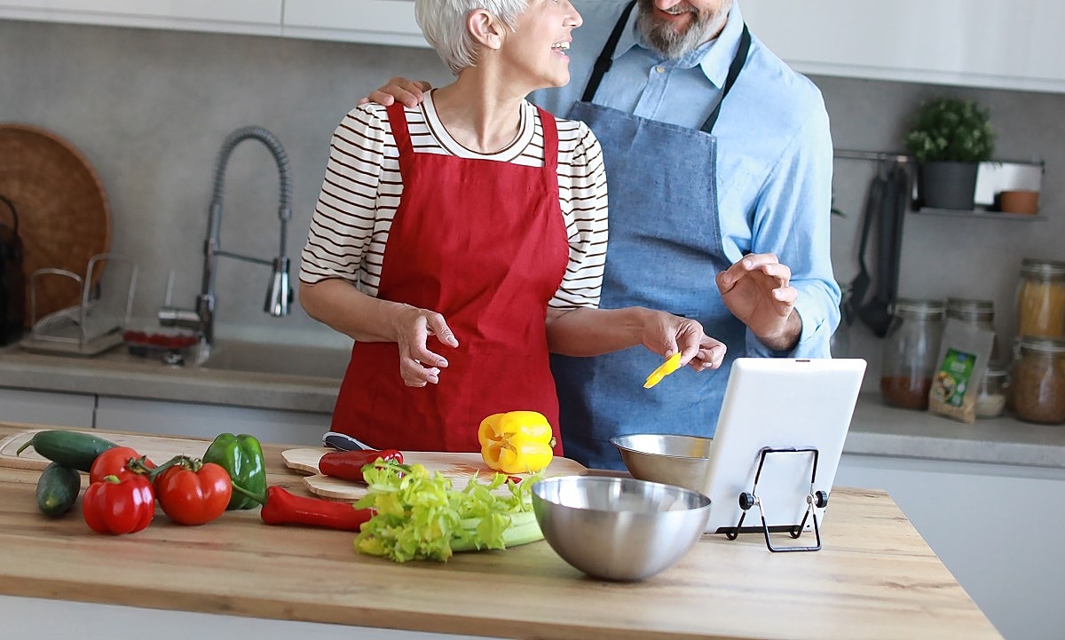 Couple cooking together in a modern kitchen.