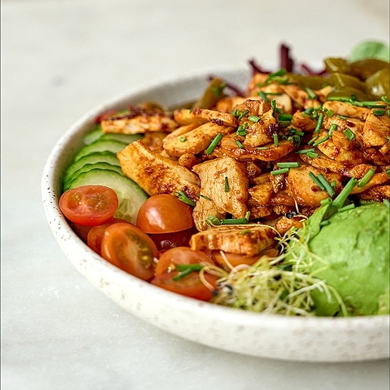 Grilled chicken salad with fresh vegetables and avocado