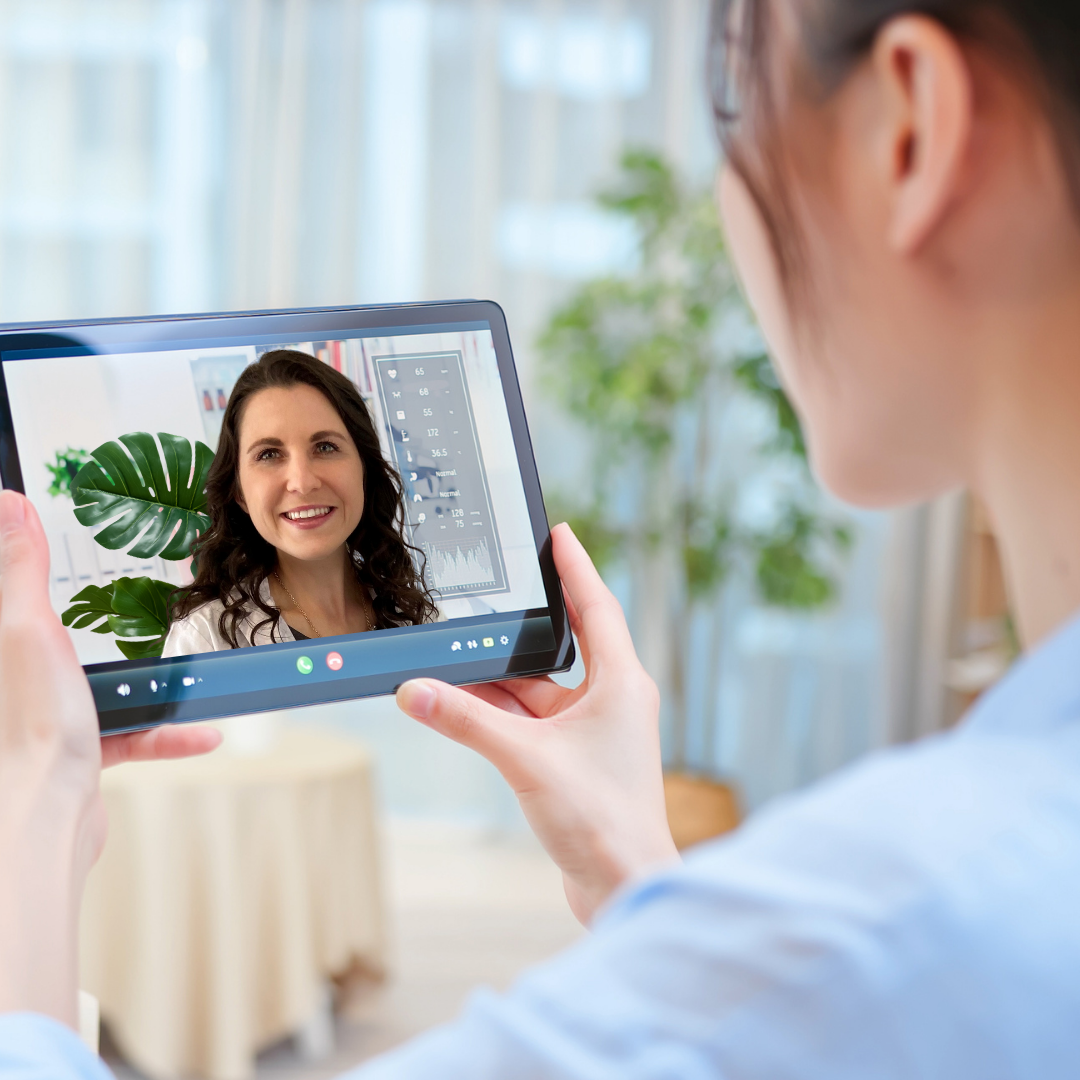 Video call between two smiling women.